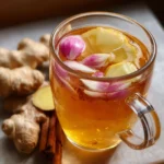 Taza caliente de infusión de cebolla, ajo, jengibre y canela recién preparada sobre fondo rústico